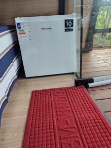 a red rug on the floor next to a box at Cantinho do Chalé in Jaboticatubas