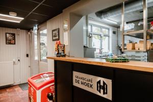 a restaurant with a counter and a trash can at Appartementen Hoek 1 in Baflo +2 photos