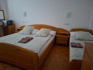 a bedroom with two beds and two night stands at Cozy Nook Stays near Rogla & Terme Zreče in Zreče