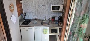 a small kitchen with a sink and a microwave at Duplex escape in Quartier Palmène