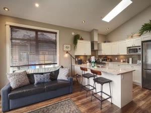 a living room with a couch and a kitchen at Oceanfront Marina & Mountain views- pet friendly in Port Renfrew +16 photos
