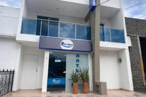 a blue and white building with a sign on it at Hotel Barcelona in Montería
