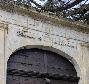 a sign above a garage door on a building at Domaine de la Dordrona in Brantome en Perigord +20 photos