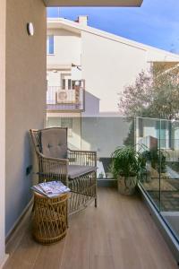 a balcony with a chair and a table at A la plage R in San Benedetto del Tronto