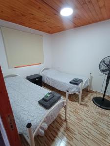 a room with two beds and a lamp in it at Cabaña Mailin in Uspallata