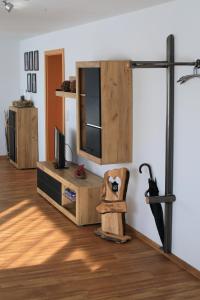 a living room with a tv and a tv stand at Albglück in Gammertingen