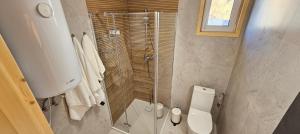 a bathroom with a toilet and a glass shower at Perłowy Port in Gąski +24 photos