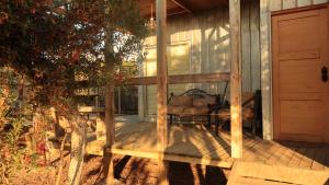 a screened in porch of a house with a tree at Cabañas Guanaqueros Arriendo Diario in Guanaqueros