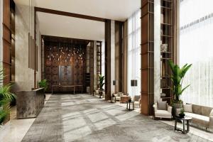 a lobby of a building with a door and plants at Kampala Marriott Hotel in Kampala