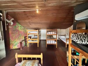 a room with several bunk beds in a room at Casa Lee Hostel in Paraty +8 photos