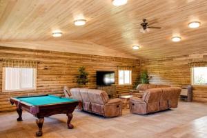 a living room with a pool table and chairs at Alaska Knotty Pine Whole Building in Palmer