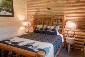 a bedroom with a bed in a log cabin at Alaska Knotty Pine Whole Building in Palmer