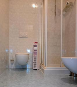 a bathroom with a sink and a toilet and a shower at Le piscine in Villa Guardia
