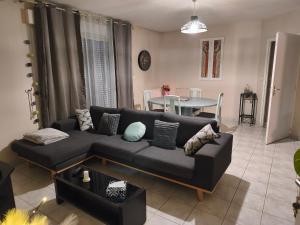 a living room with a couch and a table at Pavillon in Saint-Berthevin-sur-Vicoin
