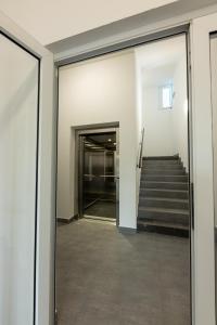 an open hallway with stairs in a building at Eternity Apartment in Štúrovo