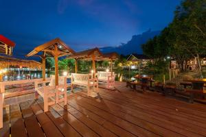 a wooden deck with chairs and a gazebo at Rabiangmai Resort in Ban Ko Krang