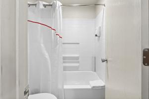 a white bathroom with a toilet and a shower at Red Roof Inn Tucson - Vail in Tucson +30 photos