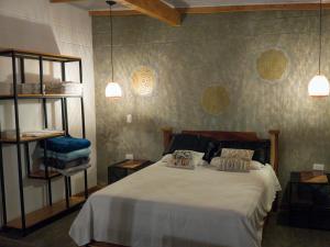 a bedroom with a bed with two pillows on it at Green mount in Medellín