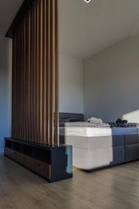 a bedroom with a bed with a mirror on it at Eternity Apartment in Štúrovo