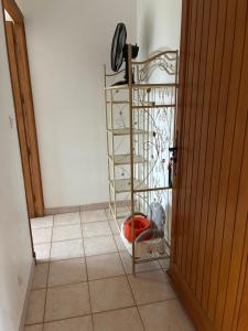 a room with a tiled floor with a iron rack at Maisonette paisible à La Roque-Gageac in La Roque-Gageac