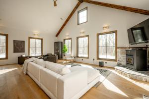a living room with a white couch and a fireplace at Deep Creek Modern by Railey Vacations in Oakland