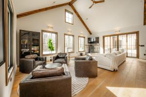 a living room with a couch and chairs and a table at Deep Creek Modern by Railey Vacations in Oakland