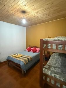 a bedroom with a bed and two bunk beds at Posada LO DE ELIAS in Tilcara