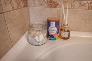 a bathroom sink with a jar of soap and a candle at Villa Bella Vista - For up to 6 people Villa with Sea & Castle view in Črni Kal +29 photos