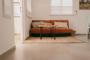 a living room with a couch and a table at אירוח משק 42 in Sheʼar Yashuv