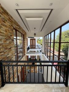 a balcony with a stone wall and windows at Ferien Villa in Kalutara