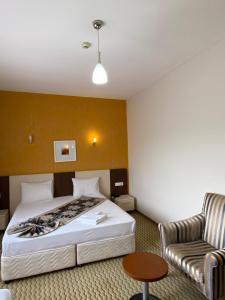 a hotel room with a bed and a chair at Legend Tem Hotel in Silivri