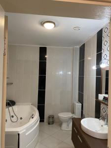 a bathroom with a tub and a toilet and a sink at Legend Tem Hotel in Silivri
