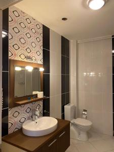 a bathroom with a sink and a toilet at Legend Tem Hotel in Silivri