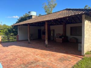a pavilion with a roof on a brick patio at Recanto do Sossego in Gravataí +3 photos