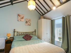 a bedroom with a bed and a chandelier at Fullers Studio in Holyhead