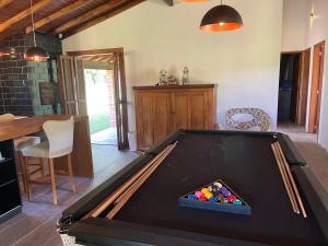 a ping pong table in a room with a pool table at Recanto do Sossego in Gravataí