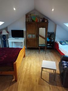 a bedroom with a bed and a desk with a computer at En coloc' chez Charlotte in Dunkerque