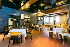 a dining room with white tables and chairs at Hotel Martina in Żnin