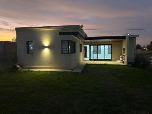 a small house with a light on the side of it at Casa Serena in Capitán Bermúdez