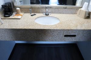a bathroom counter with a sink in a bathroom at legacy inn paducah in Paducah