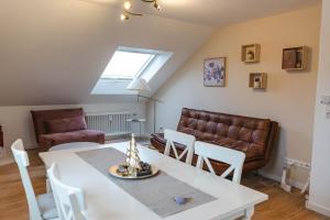 a living room with a table and a couch at Dreiländer Blick Apartments in Lörrach