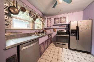 a kitchen with purple walls and stainless steel appliances at Creatives Retreat for Artists & Lovers in Gainesville +19 photos