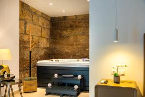a bathroom with a tub and a table and a stool at AC Encanto in La Cisnera +46 photos