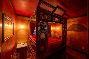a bedroom with an ornate wooden bunk bed at Creatives Retreat for Artists & Lovers in Gainesville