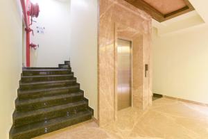 a staircase in a building with a glass door at Super OYO 77736 Hotel Starlight in Kānpur
