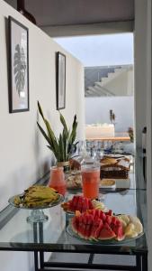 a buffet with plates of food on a glass table at Asas da Maré Pousada in Bragança
