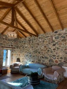 a living room with a stone wall at Konstantina 2 in Ayía Varvára