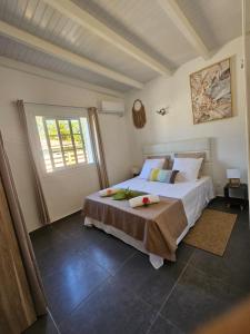 a bedroom with a large bed and a window at Villa Fleur de Lys MAE in Morne-à-lʼEau +27 photos