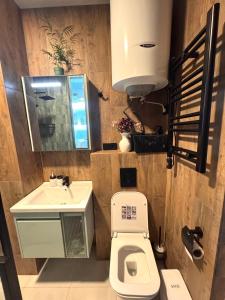 a bathroom with a toilet and a sink at Seafront Gonio Studio in Gonio