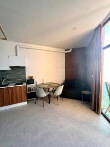 a kitchen and dining room with a table and chairs at Seafront Gonio Studio in Gonio